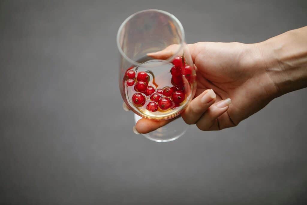 person holding a glass of alcohol