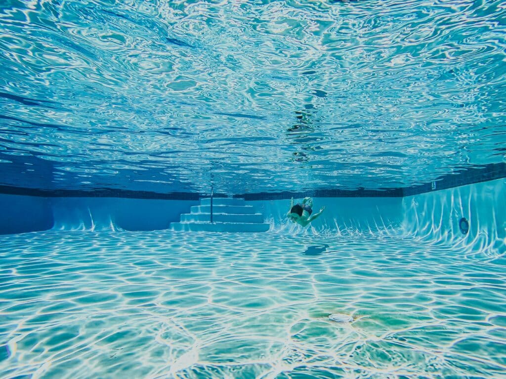 person under water in pool