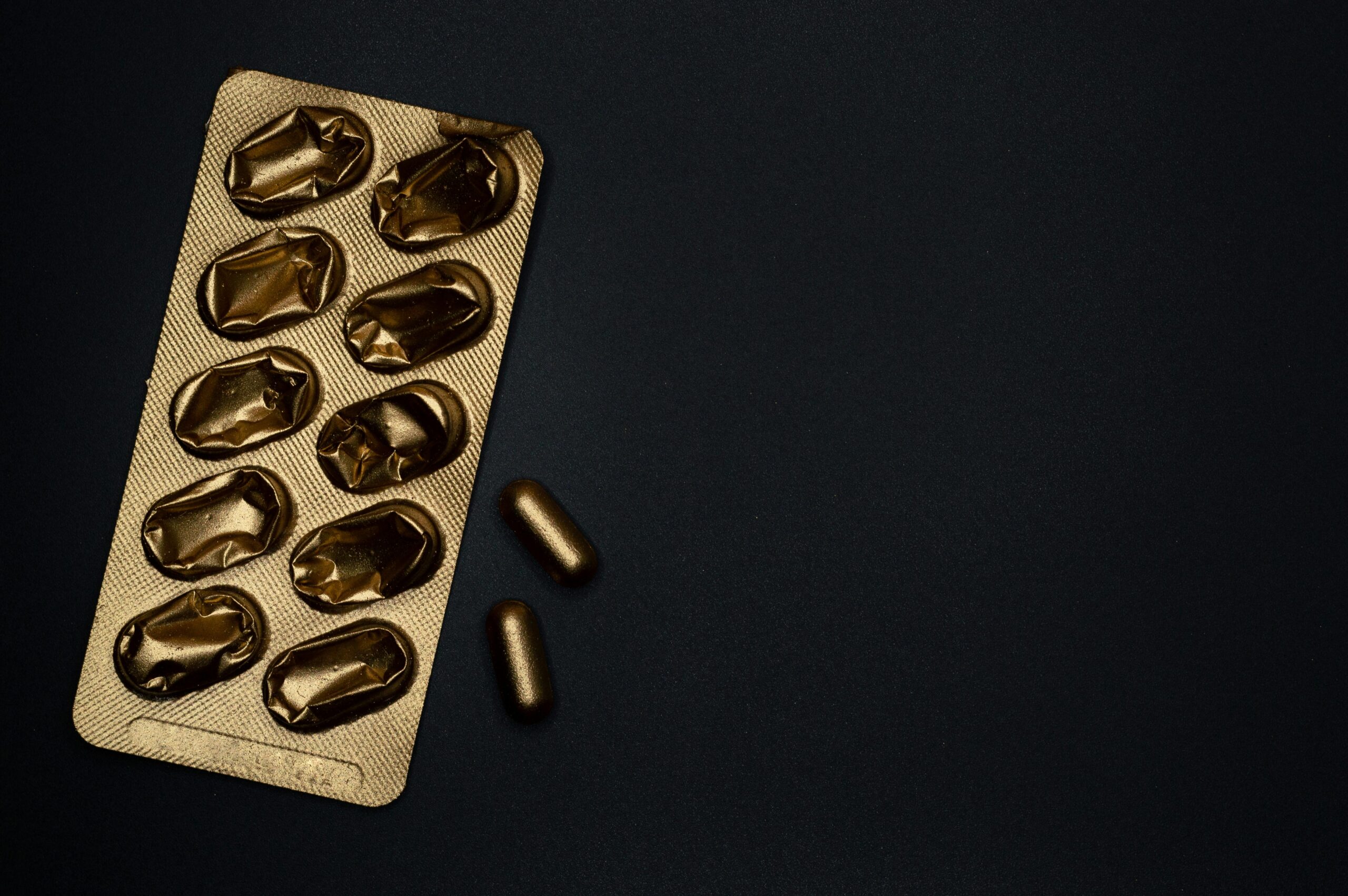 gold pill on black background