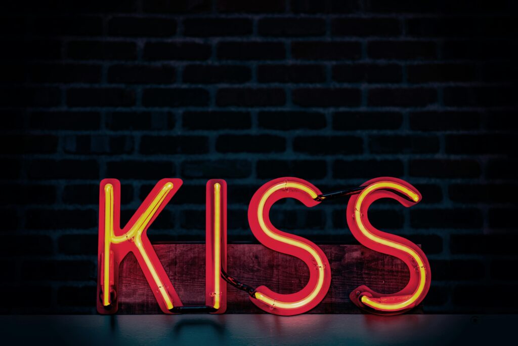 neon sign of the word kiss