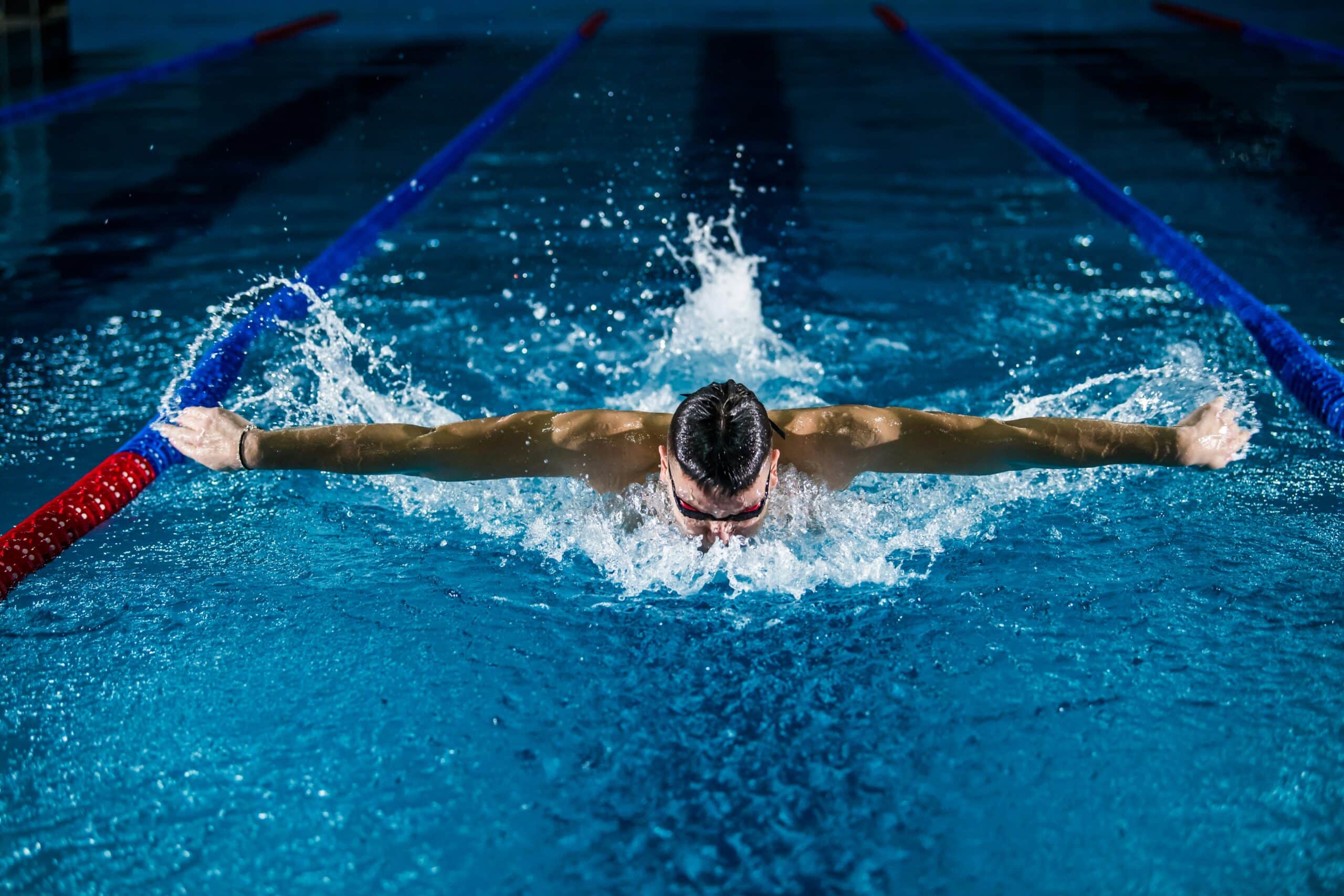 man swimming in pool