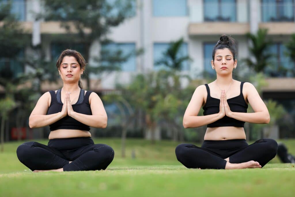 women meditating together outside