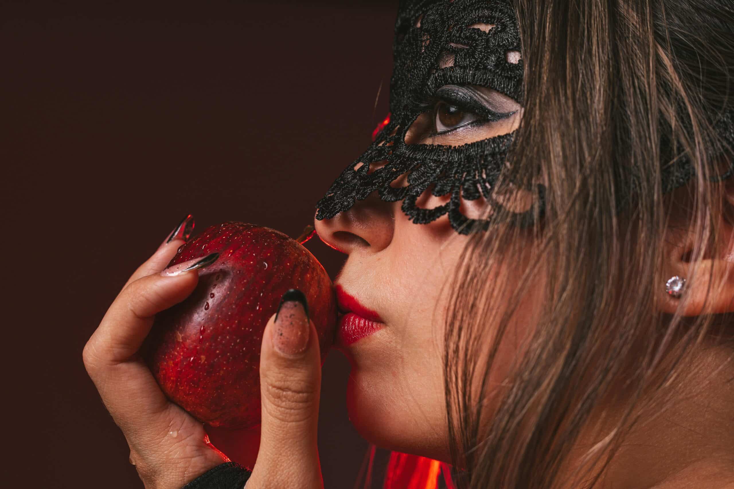 woman biting into apple