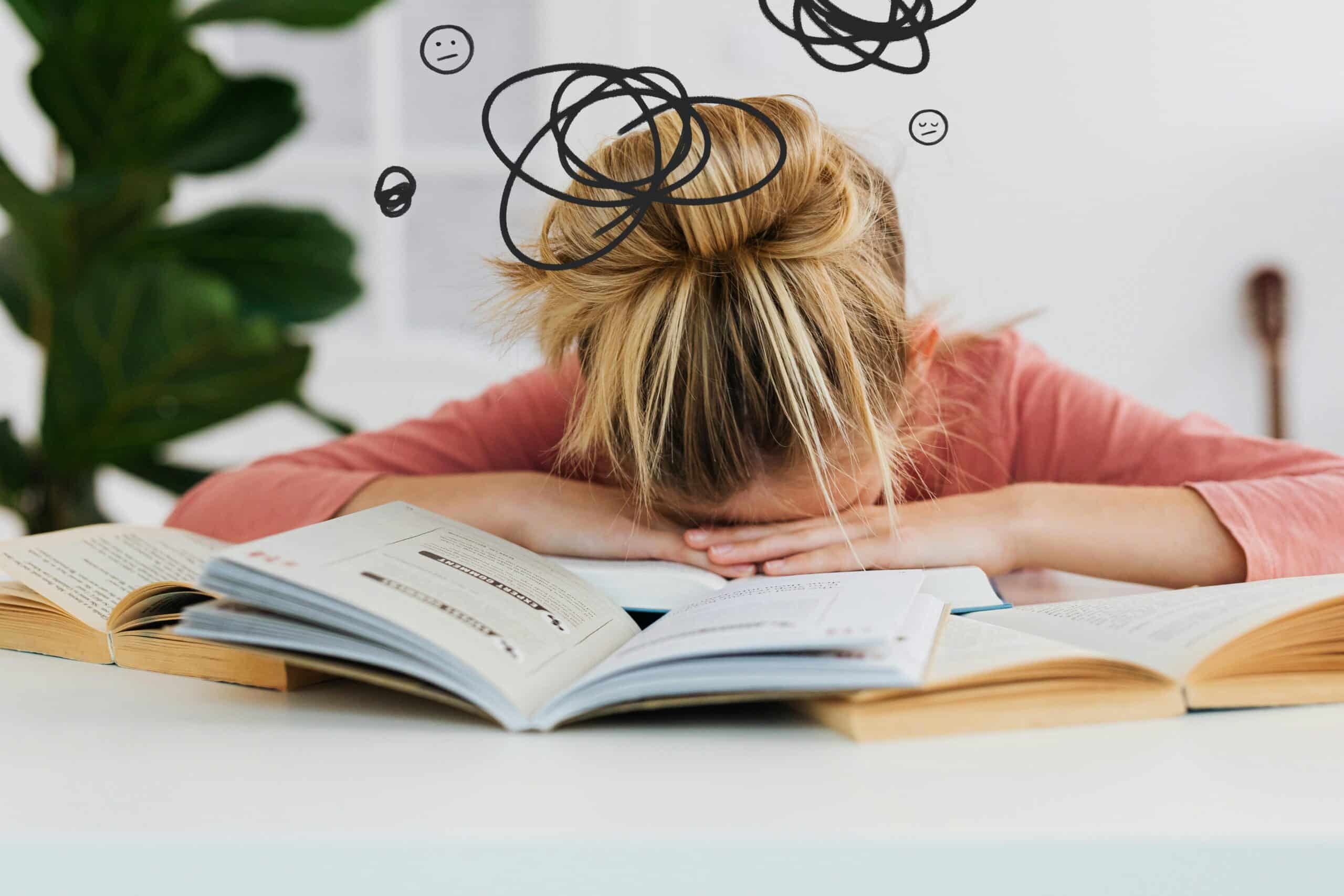 person with head on top of book