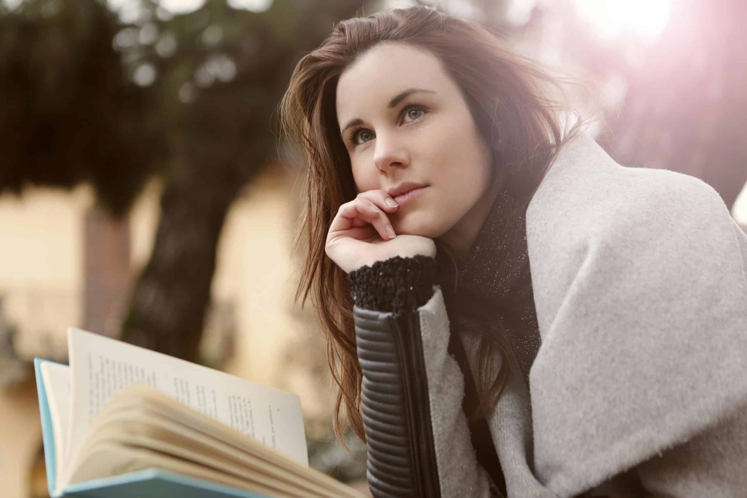 woman reading book and thinking