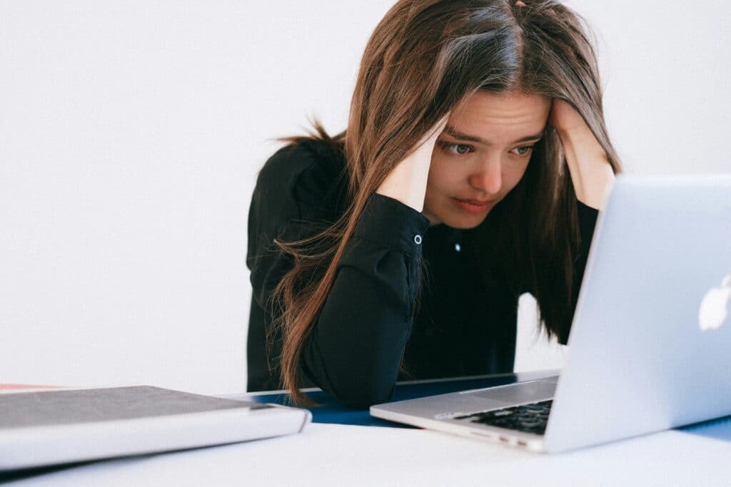 woman having anxiety about laptop