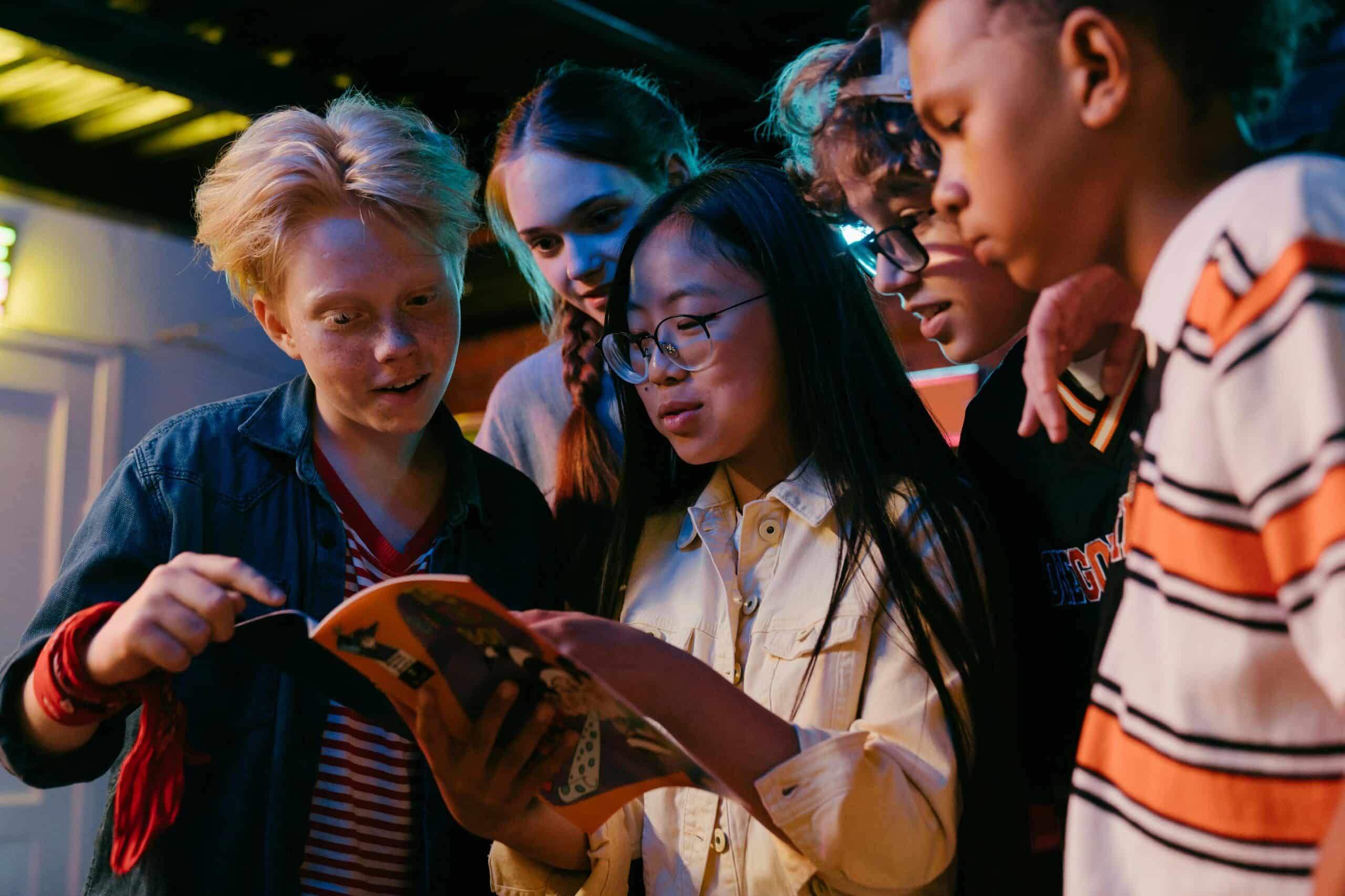 teenagers reading a book together