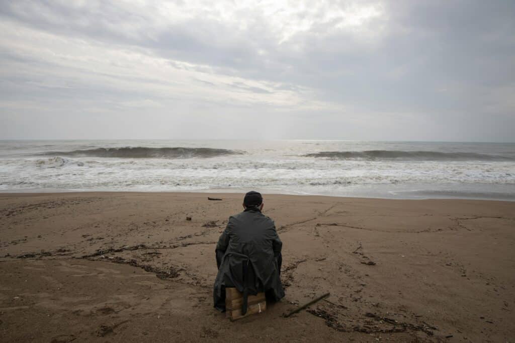person looking at the ocean on the beach