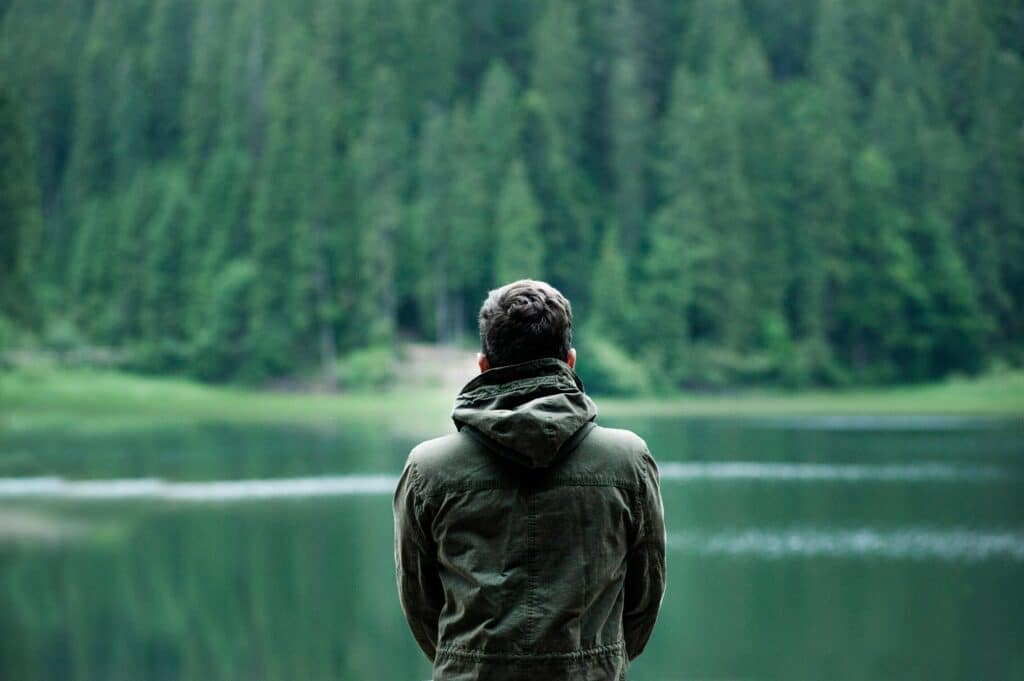 young man looking over the lake