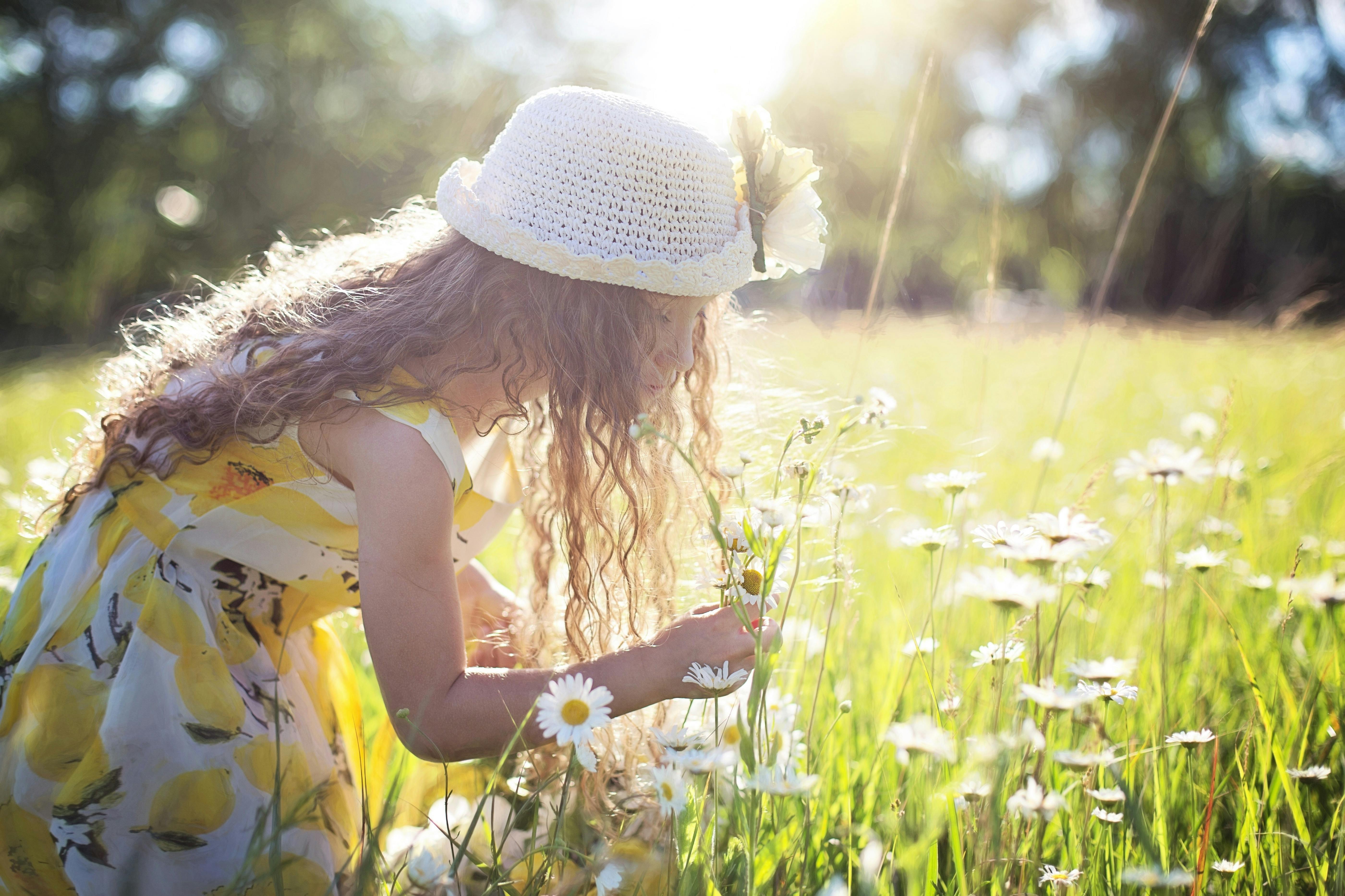 little girl looking at flowers