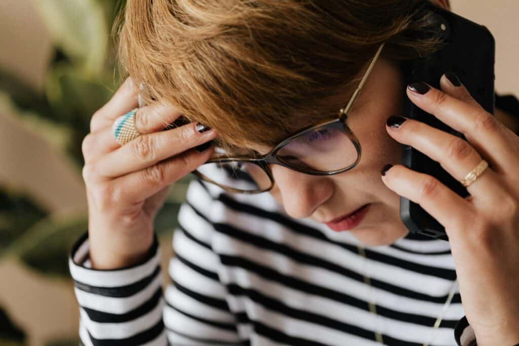 woman being depressed on the phone