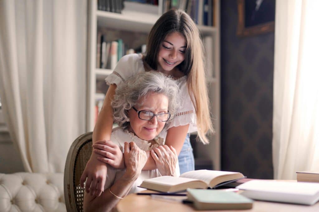 kid and grandma reading together