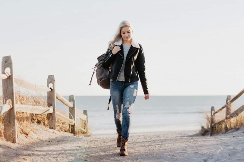young woman walking at the beach