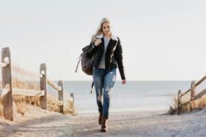 young woman walking at the beach