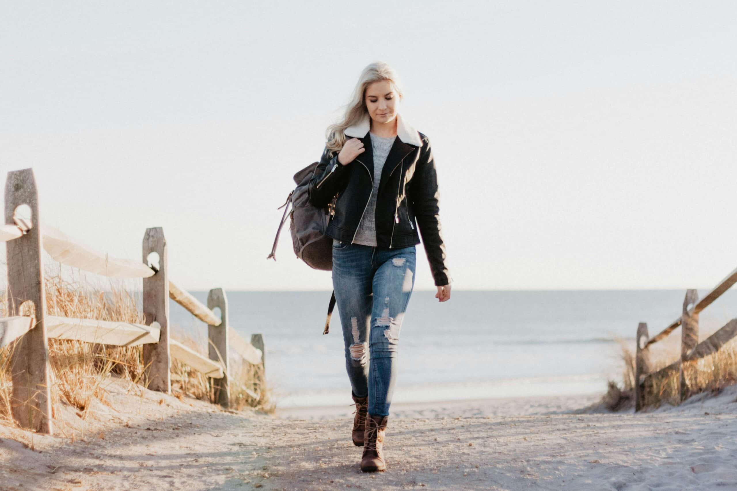 young woman walking at the beach